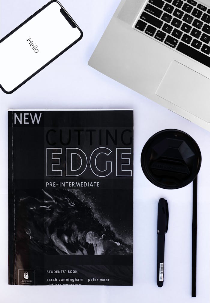 The Art of Drawing Readers In: Your attractive post title goes here Flat lay of laptop, smartphone, book, and coffee for a contemporary workspace.